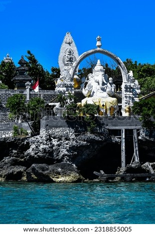 Ganesha statue at Menjangan island temple, West Bali, Indonesia. Blue sea water as foreground, clear blue sky as background  Royalty-Free Stock Photo #2318855005