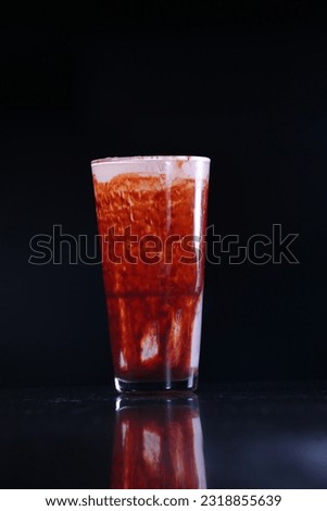 summer drink in the large glass, dark background 
