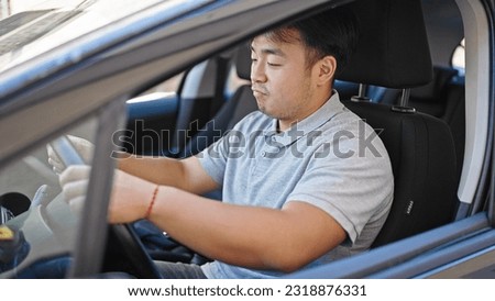  Chinese man driving car at street