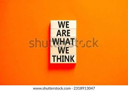 We are what we think symbol. Concept word We are what we think on wooden block. Beautiful orange table orange background. Business We are what we think concept. Copy space.
