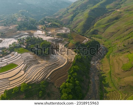 The pouring water season makes the terraced fields of Y Ty commune, Lao Cai province appear with brown soil blending with the beautiful sky. Travel and landscape concept in North West Vietnam