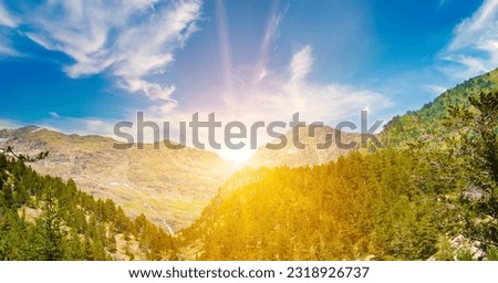 Picturesque mountain landscape and sunrise. Summer, bright sunny day in the Pyrenees, Andorra. Wide photo.