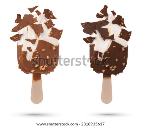 Chocolate ice cream isolate on a stick flying pieces of chocolate icing. Chocolate ice cream on a white isolated background with scattered pieces of chocolate and vanilla inside.