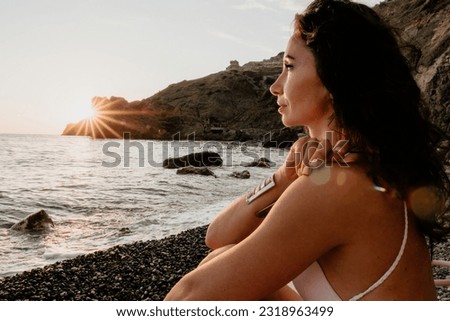 Woman sea yoga. Happy woman meditating in yoga pose on sunset beach, ocean and rock mountains. Motivation and inspirational fit and exercising. Healthy lifestyle outdoors in nature, fitness concept.