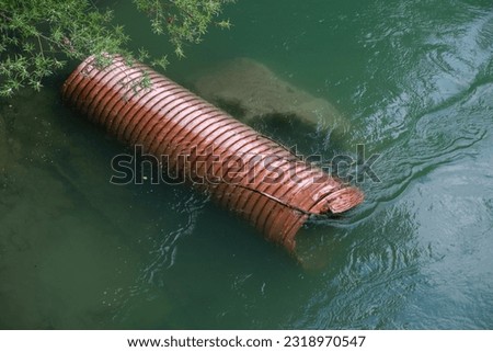 Environmnetal devestation. Plastic tube under water