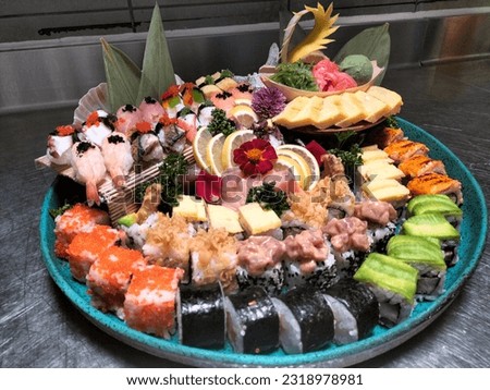 Japanese sushi food. maki and rolls with tuna, salmon, shrimp, crab, mango and avocado. all you can eat. Rainbow  sushi rolls, uramaki and nigiri. This is a sushi palette with, black, green colors.
