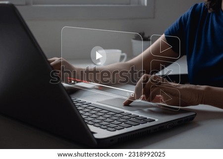 Video streaming on internet. Woman watching online movie or TV series on laptop. Video on demand technology, subscription based live digital stream or channels, multimedia player with play button.