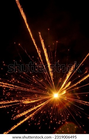 a sharp photograph of a colorful flame from a single firework at new year eve Royalty-Free Stock Photo #2319006495