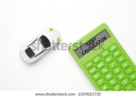 Flatlay picture of car diorama with debt calculator word on calculator on white background