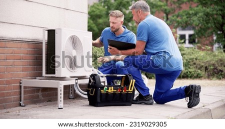 Air Conditioner Install. Commercial HVAC Maintenance Service Royalty-Free Stock Photo #2319029305