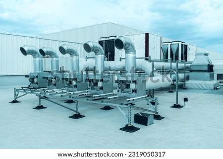 The air conditioning and ventilation system of a large industrial building is located on the roof. It consists of air ducts, air conditioning, smoke removal and ventilation Royalty-Free Stock Photo #2319050317