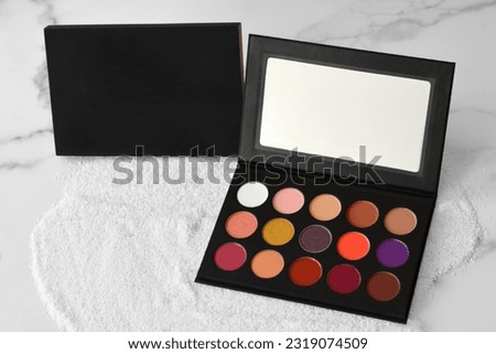 Black eye shadow palette box on marble floor Royalty-Free Stock Photo #2319074509