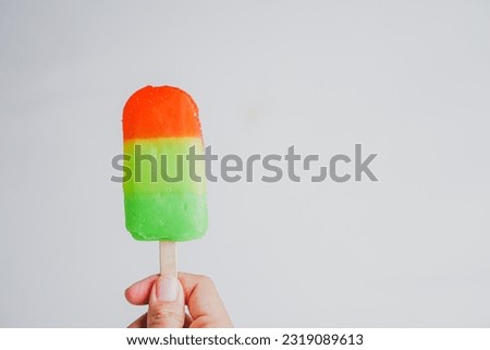 hand holding ice cream stick