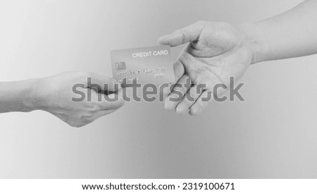 Two hands send and receive gold credit card .Black and white picture