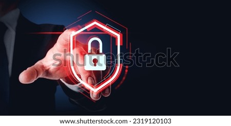 Businessman finger touch red glowing protective shield with padlock, dark background. Concept of cyber security, data protection and confidential information Royalty-Free Stock Photo #2319120103