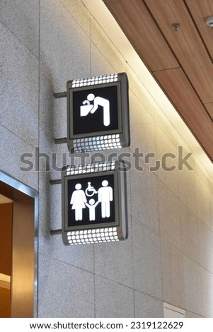 Toilets icon. Public restroom signs with a disabled access symbol. Modern public toilet sign on the wall Interior of airport terminal. Restroom WC Toilet icons. Men and women WC signs for restroom.