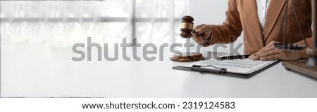 The judge is signing the document. hammer with justice lawyer Businesswoman in suit working on documents, law, advice and justice concept and contract signing. copy space, panorama, banner