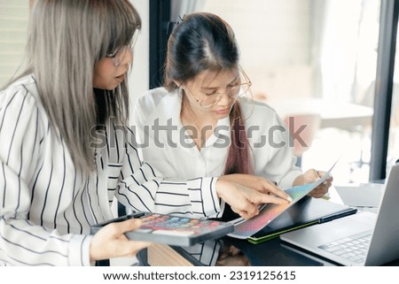 graphic designer working with laptop and color swatch. creative man using digital tablet at modern office. 