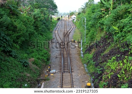 Transfer of railroad tracks at a station flanked by mountains