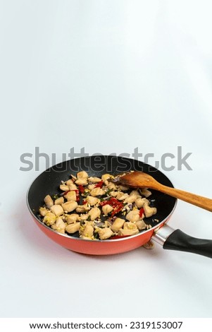 Seasoned Chicken Breast on a Frying Pan
