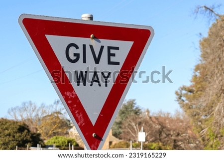 give way sign against blue sky