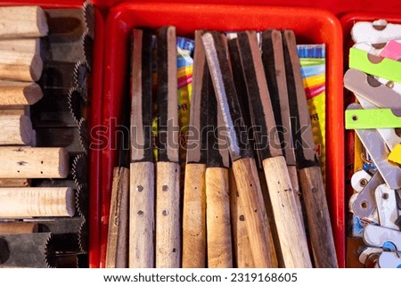 This stock photo shows a large, handmade knife displayed on a wooden block.