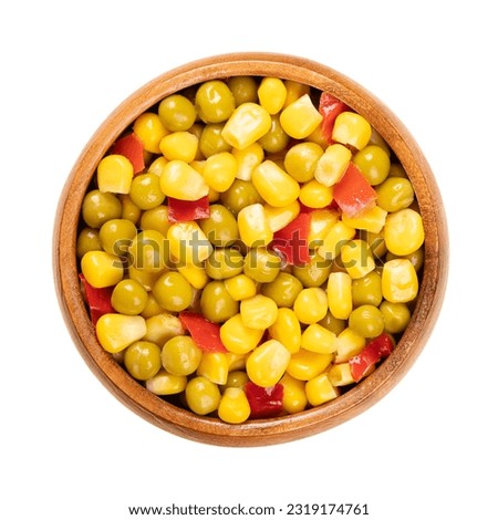 Mix of canned corn, green peas and diced red bell pepper, in a wooden bowl. Ready to eat Mexican maize mix, as a side dish to a barbecue. Isolated, from above, close-up, over white, macro food photo.