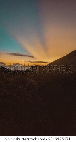 The view of sunrise on the mountain in the morning with a bright sky.