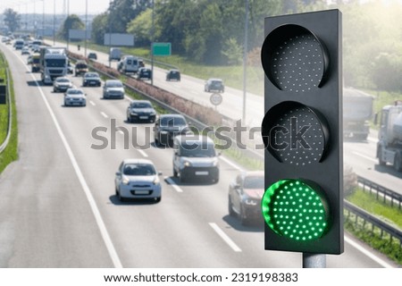 Green traffic light on a background of highway Symbol of green transportation
