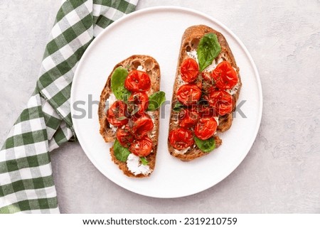 bruschetta with tomatoes on a white plate Royalty-Free Stock Photo #2319210759