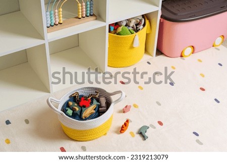 Children room with shelves and colorful storage baskets and boxes. Rainbow wooden toys. Space organizing at children s room. Interior design. Playroom Royalty-Free Stock Photo #2319213079