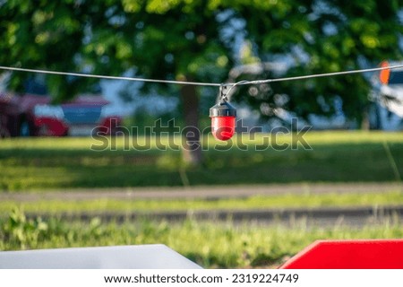 A red lantern is hanging on a rope