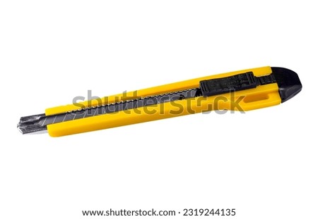 yellow stationery cutter knife isolated on white background Royalty-Free Stock Photo #2319244135