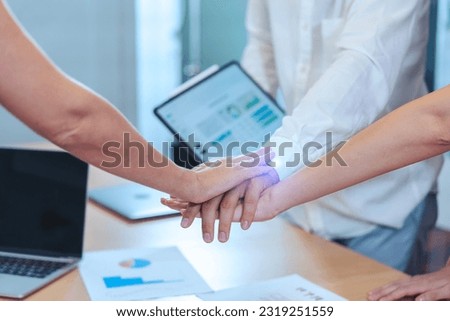 Team of workers complete their work with their joint hand together, three people show their energy to get work done in the meeting room. Royalty-Free Stock Photo #2319251559