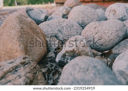 Rounded sea stones as a blind area around the cottage. Small sea stones, gravel. Background. Textures