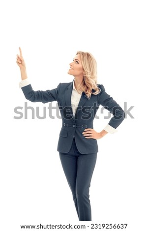 Bright photo - happy smiling business woman in grey confident suit, show, advertise, point, hold, demonstrate some product slogan text area copy space. Businesswoman promote, isolated white background