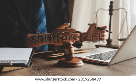 Business and lawyers discussing contract papers with brass scale on desk in office. Law, legal services, advice, justice and law concept picture with film grain effect Royalty-Free Stock Photo #2319258439