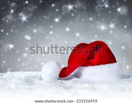 Santa Claus hat with snow and silver snowfall background 