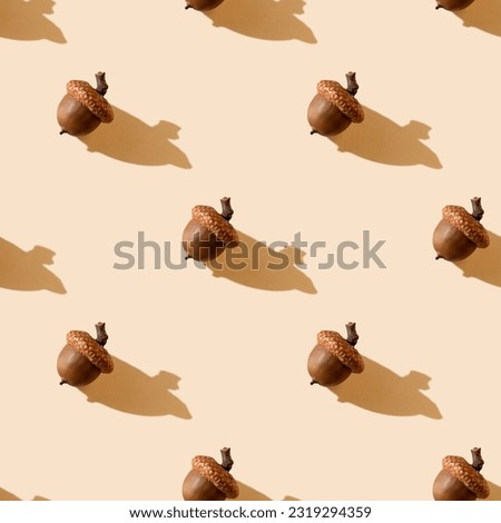Acorns on pastel background with shadows. Seamless pattern. Autumn print. Thanksgiving day. Botany design