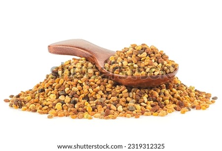 Raw organic honey bee pollen in wooden spoon isolated over white background. Bee bread. Royalty-Free Stock Photo #2319312325