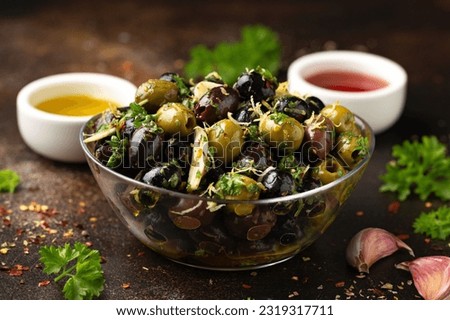 Marinated olives with fresh herbs, garlic, red wine vinegar and lemon zest Royalty-Free Stock Photo #2319317711