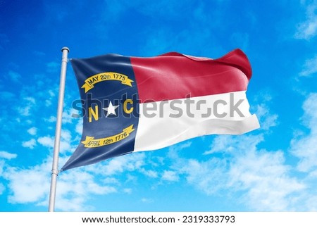 North Carolina flag waving in the wind, blue sky background