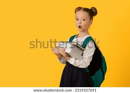 Back To School. Portrait Of Surprised Nerdy Schoolgirl Carrying Heavy Books And Looking At Camera, Cute Preteen Female Child Tired Of Homework, Standing Isolated On Yellow Background, Copy Space