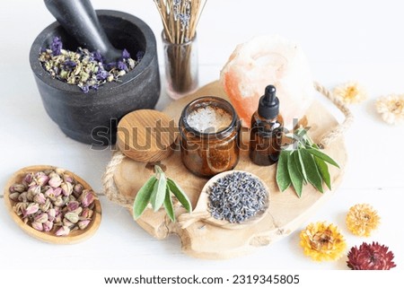 Botanical blends, herbs, essencial oils for naturopathy. Natural remedy, herbal medicine, blends for bath and tea on wooden table background Royalty-Free Stock Photo #2319345805