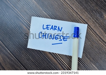 Concept of Learn Chinese write on sticky notes isolated on Wooden Table.