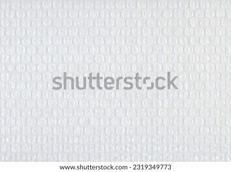 Polyethylene bubble wrap used to pack and ship fragile items in boxes. Royalty-Free Stock Photo #2319349773