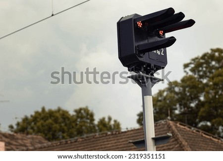 Red signal of the semaphore on the railway with sky in background.