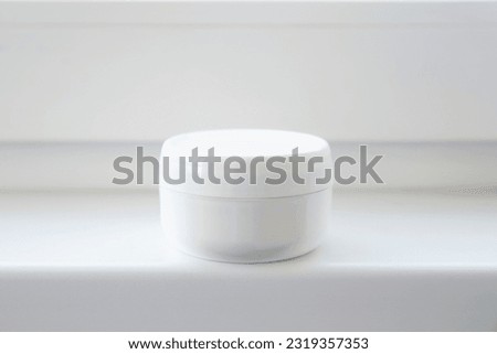 One white plastic cosmetic jar on a white background. Royalty-Free Stock Photo #2319357353