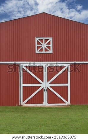 Classic Red Barn on Green Grass With Blue Sky. Rural East Texas  Royalty-Free Stock Photo #2319363875
