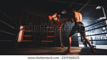 Asian and Caucasian Muay Thai boxer unleash knee attack in fierce boxing training session, delivering knee strike to sparring trainer, showcasing Muay Thai boxing technique and skill. Spur Royalty-Free Stock Photo #2319368225